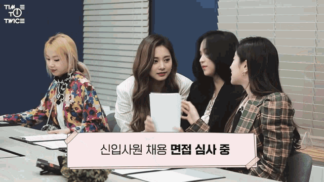 a group of women sit around a table with a sign that says twice on it