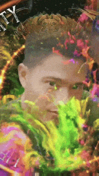 a man 's face is surrounded by a colorful painting with the letter t on it