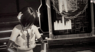 a black and white photo of a woman standing in front of a computer screen