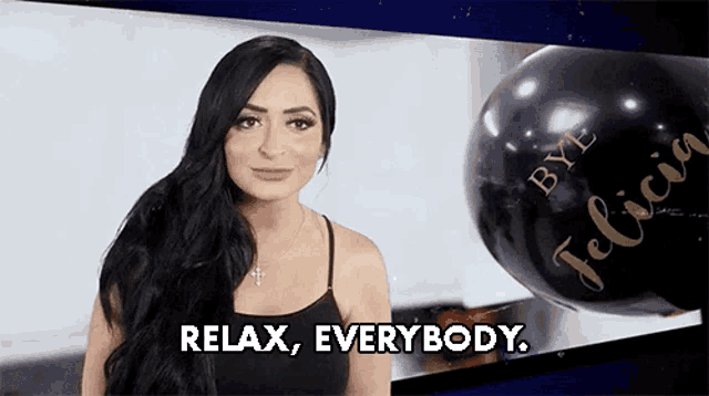 a woman says relax everybody in front of a black balloon