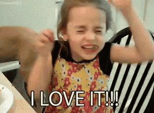 a little girl is crying while sitting in a chair and saying `` i love it '' .