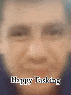 a close up of a man 's face with the words " happy tasking " below it