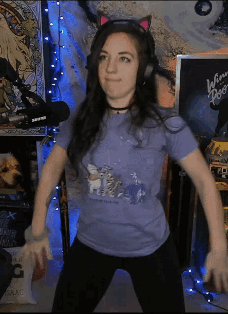 a woman wearing a purple shirt with winnie pooh on it