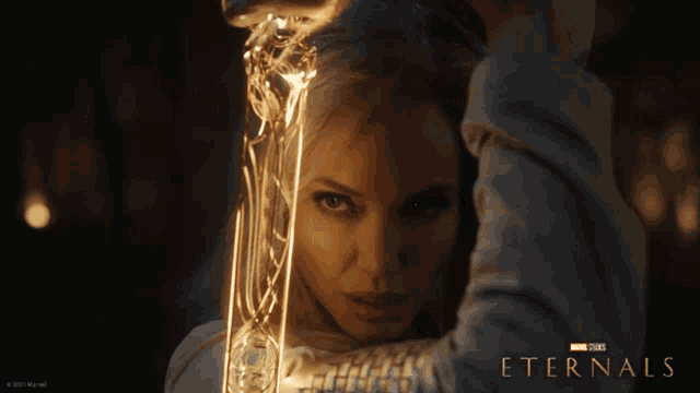 a poster for the movie eternals shows a woman