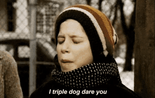 a young boy wearing a hat and scarf says i triple dog dare you