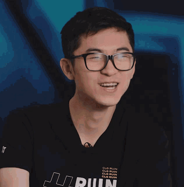 a man wearing glasses and a black shirt says " definitely "