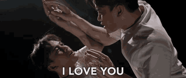 a man with a tattoo on his arm is holding another man 's arm and says " i love you "