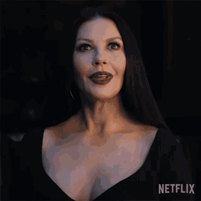 a woman in a black dress with a netflix logo on the bottom