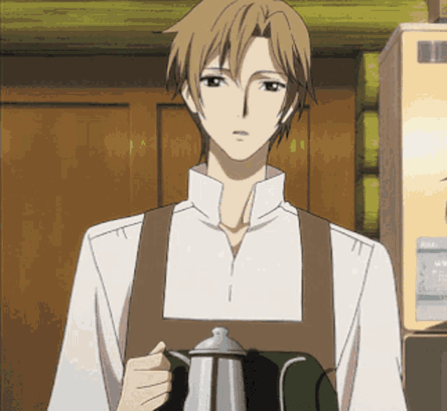 a man wearing an apron is holding a coffee pot