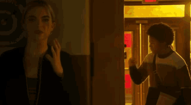 a man and a woman are standing next to each other in a dark room .