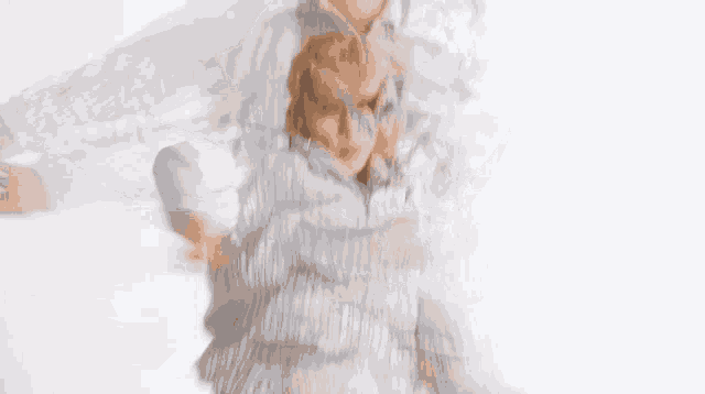 a blurry picture of a man in a striped shirt with his eyes closed .