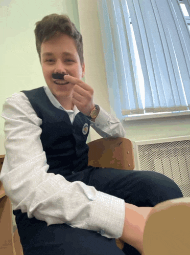 a young man with a fake mustache on his nose