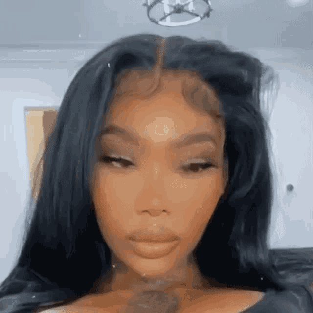 a close up of a woman wearing a lace front wig .