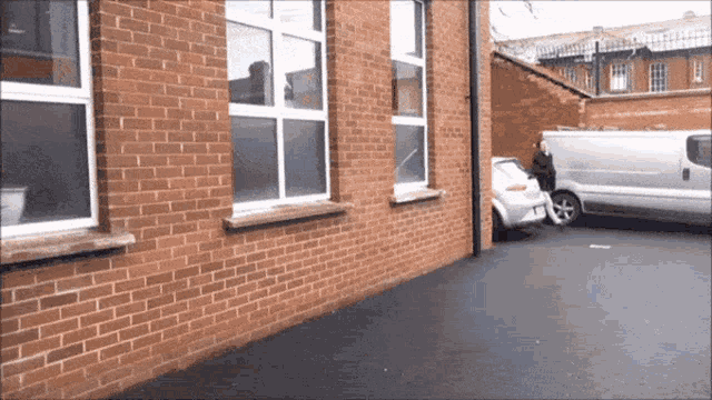 a brick building with a white van parked in front of it