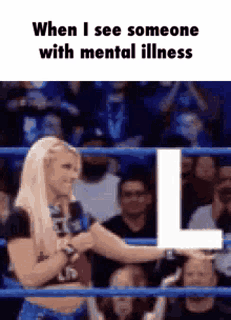 a woman in a wrestling ring is holding a letter l .