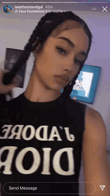 a woman is wearing a black tank top that says dior on it