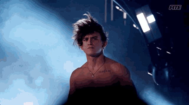 a shirtless man with a tattoo on his chest that says xiii and xiii