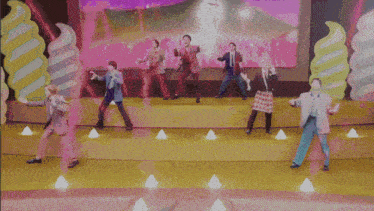 a group of people are dancing on a stage