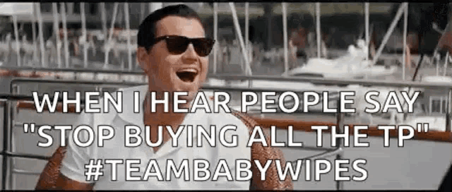 a man wearing sunglasses is sitting on a boat and laughing while people say `` stop buying all the tp '' .