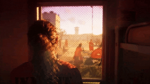 a woman looking out a window with a shirt that says " prisoner " on it