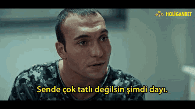 a man in a camouflage shirt says sende çok tatli degilsin simdi dayi