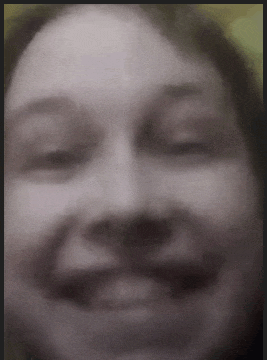 a blurry picture of a woman 's face with her eyes closed and her mouth open