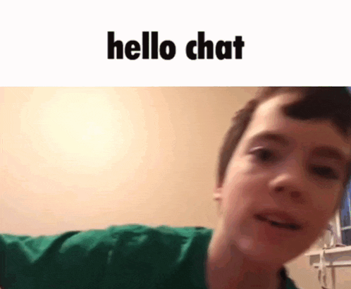 a young boy in a green shirt is talking on a video call with the words hello chat above him .