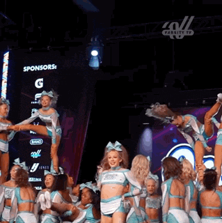 a group of cheerleaders are performing in front of a screen that says sponsors g