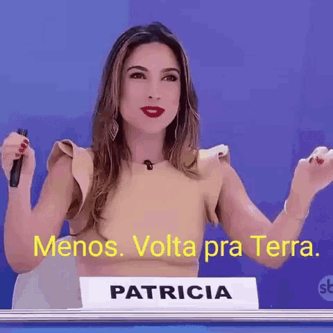 a woman is holding a microphone while standing in front of a sign that says patricia .
