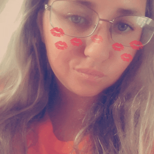 a woman wearing glasses has red lips painted on her face