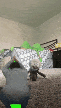 a person is playing with a stuffed plants vs zombies toy