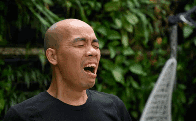 a man with his eyes closed and his mouth wide open