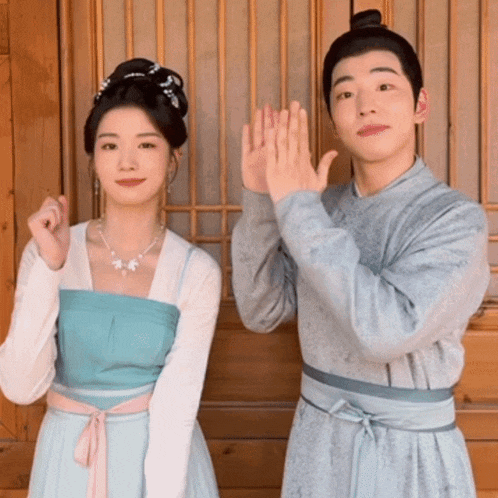 a man and a woman are standing next to each other and making funny faces