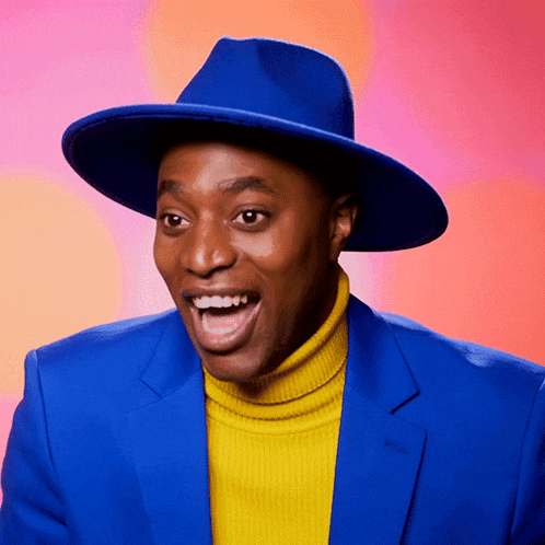 a man wearing a blue hat and a yellow turtleneck sweater