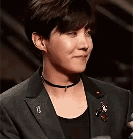 a close up of a man wearing a suit and choker .