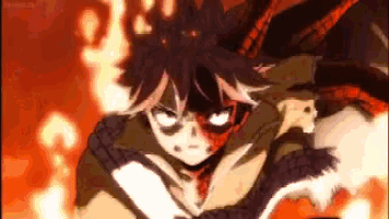 a close up of a person 's face with fire coming out of his head .