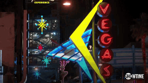 a vegas sign is lit up at night