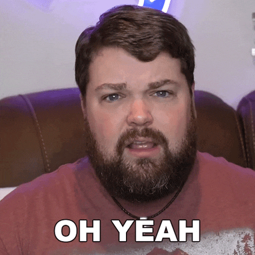 a man with a beard has the words oh yeah on his shirt