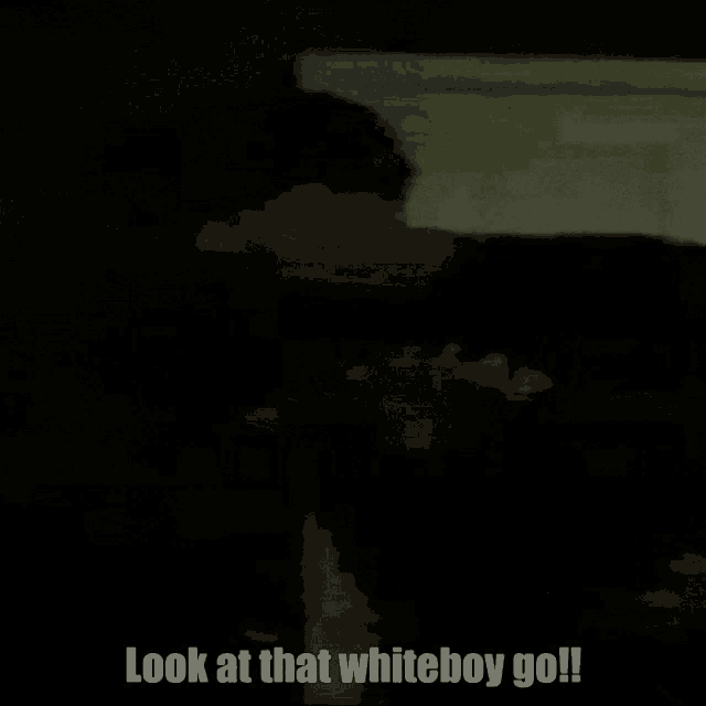 a man in a black shirt is standing in the dark and says `` look at that whiteboy go '' .
