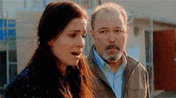 a man and a woman are standing next to each other .