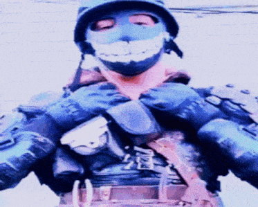 a man wearing a helmet and a mask with a smiley face on it