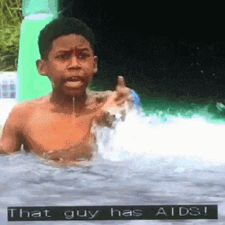 a boy in a pool with the words that guy has aids written on the bottom
