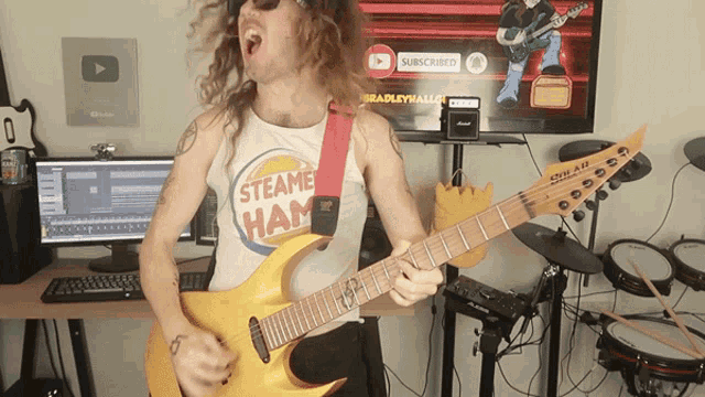 a man is playing a guitar and wearing a shirt that says steame ham