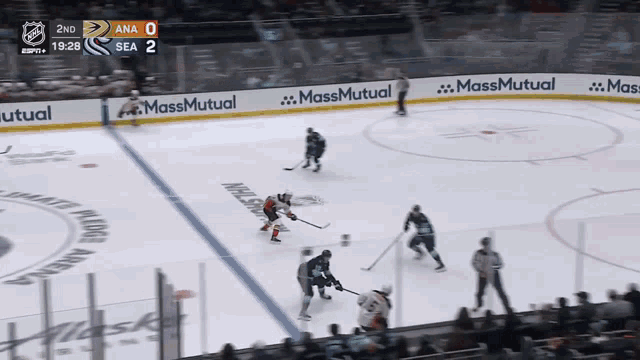 a hockey game is being played in a stadium with ads for massmutual on the ice