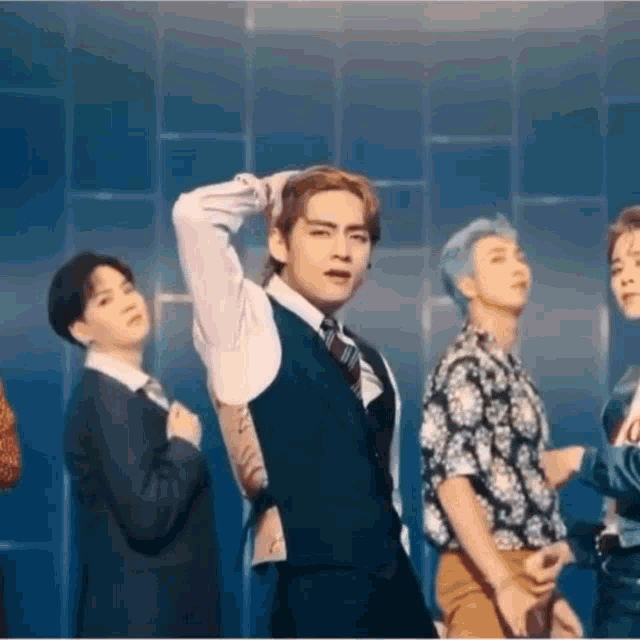 a group of young men are standing next to each other on a stage .