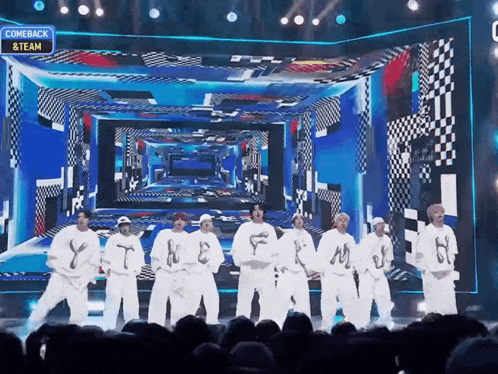 a group of dancers on a stage with a sign that says comeback & team on it