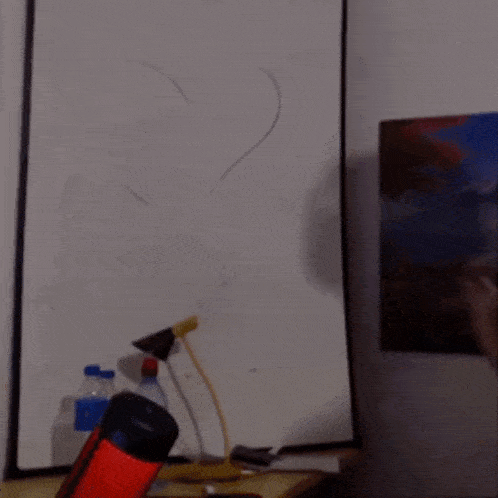 a man in headphones is writing on a white board