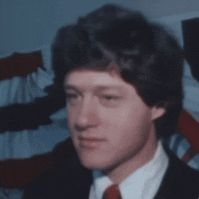a close up of a man 's face with a red tie