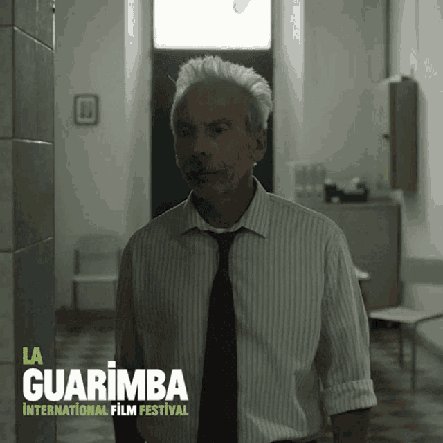 a poster for la guarimba international film festival with a man in a striped shirt