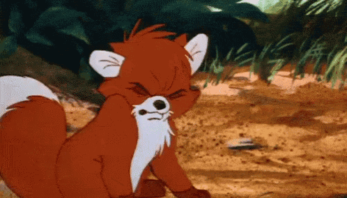 a cartoon fox with a white beard is sitting in the dirt and looking at the camera .